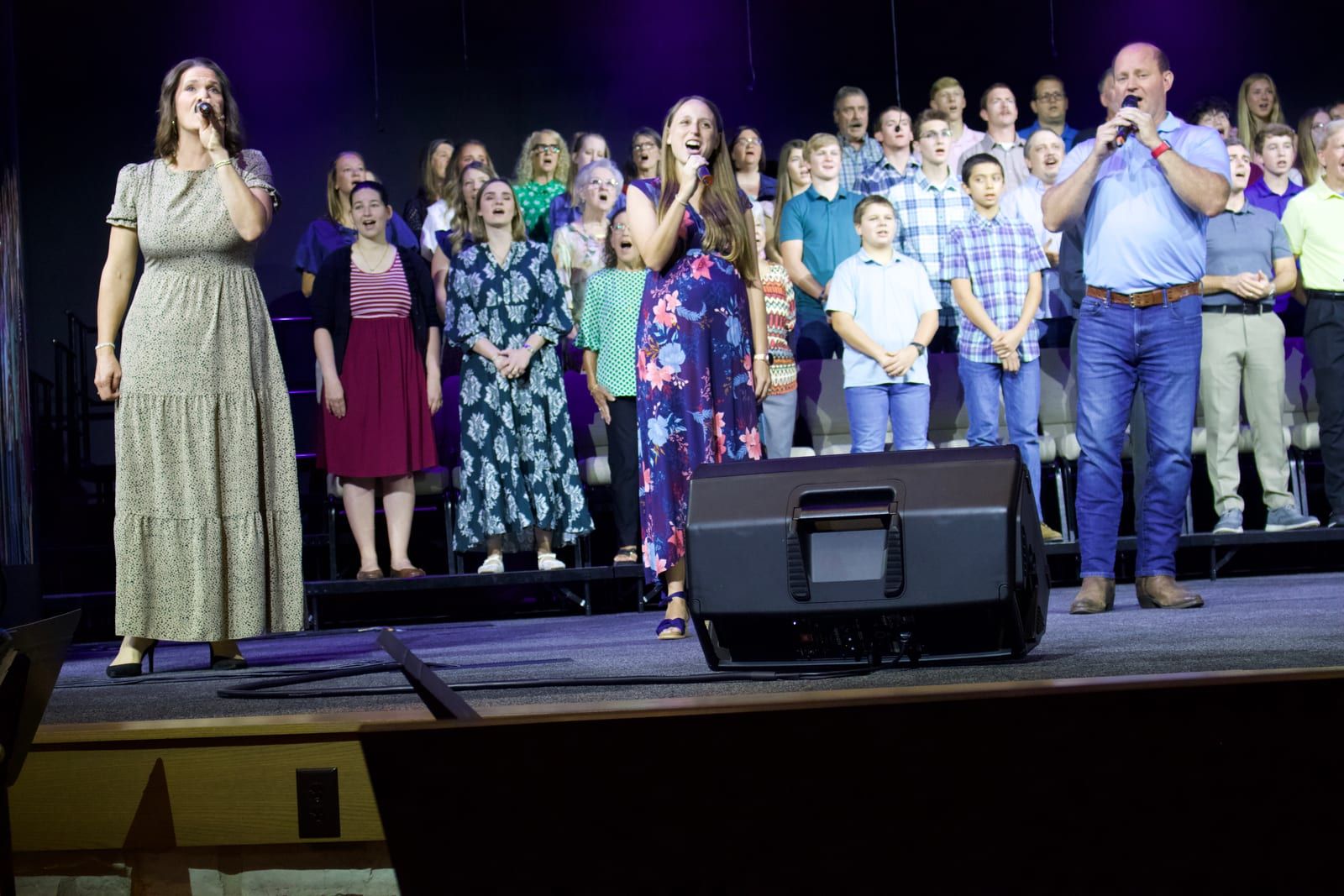 Students singing in the choir alongside adult members.